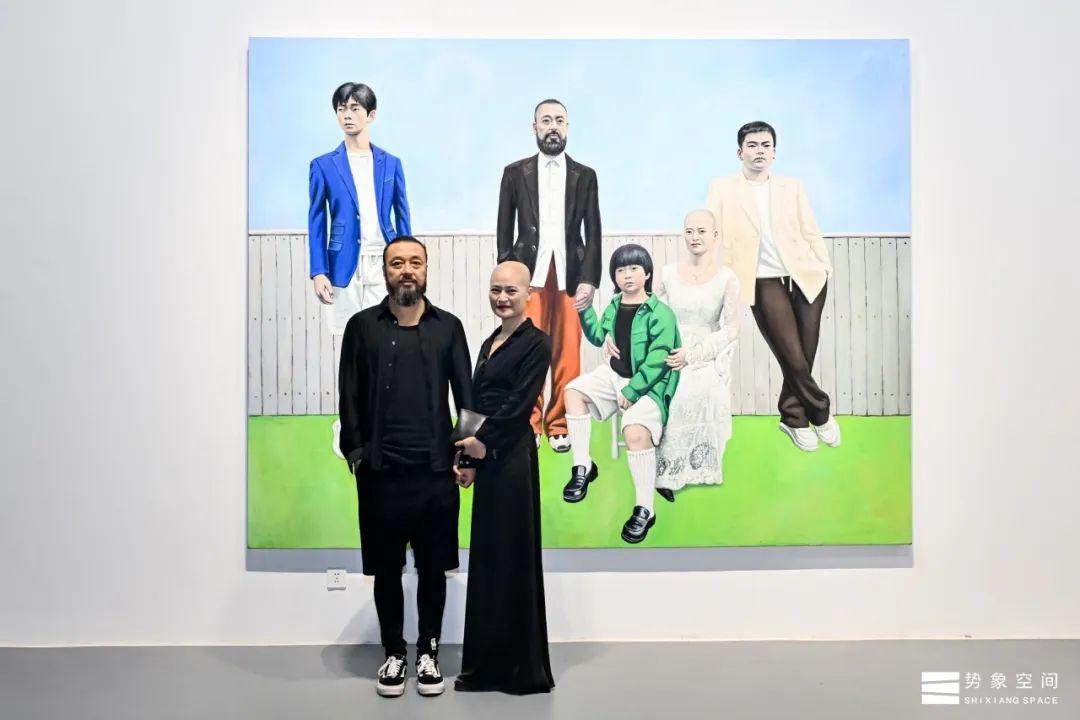 10 Artists pose in front of their works at the exhibition.jpg